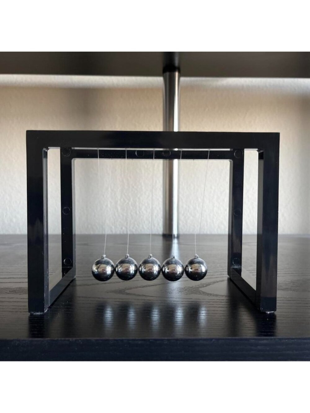 Black Newton's Cradle with five silver balls #newtons #pendulum